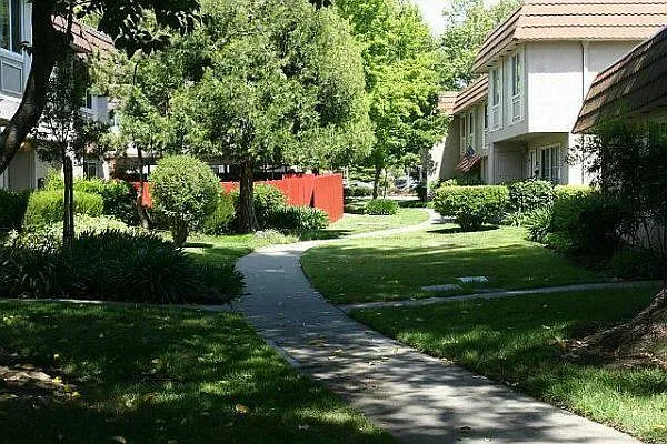 View of the Green with walking path that leads to Shopping Center across the street