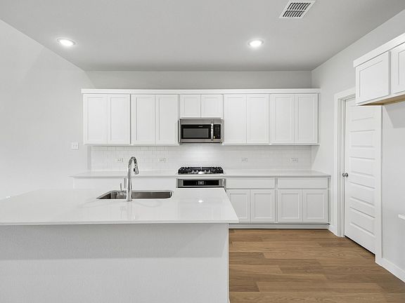 Kitchen in the Winters home plan by Trophy Signature Homes - REPRESENTATIVE PHOTO