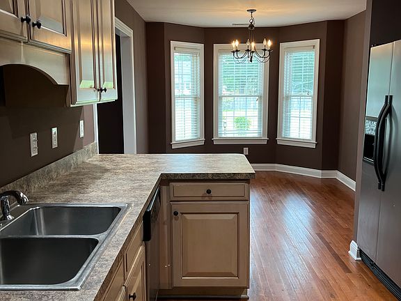 Kitchen with breakfast nook. Stainless steel appliances. New stove.
