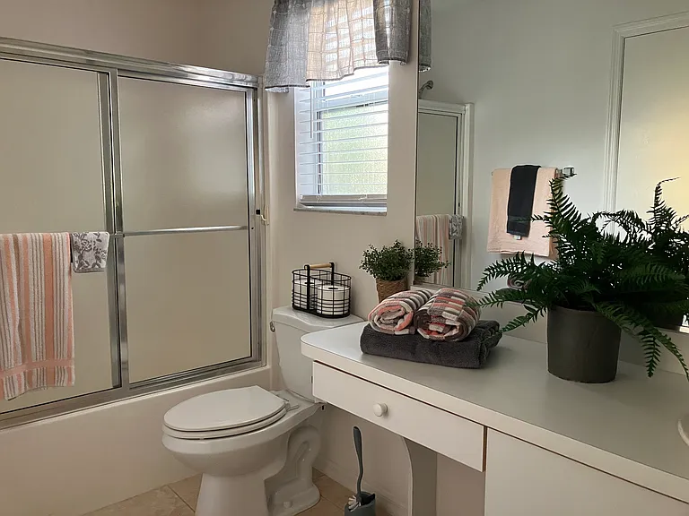 Guest bathroom-tub/shower combo. Large linen closet