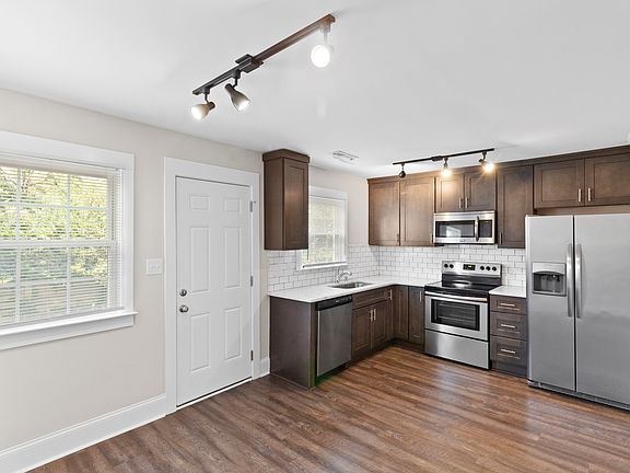 The back door flows into a back patio area and long stretch of backyard.