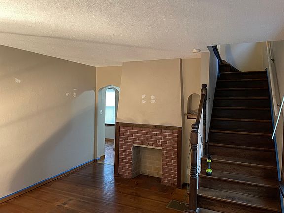 Living room with decorative fireplace. Whole house currently being painted
