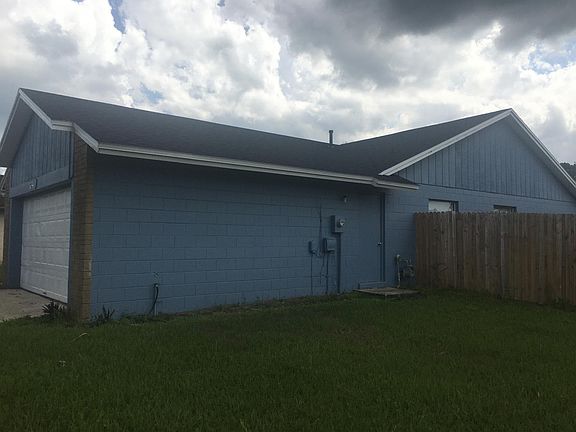 Side of home showing fence for backyard