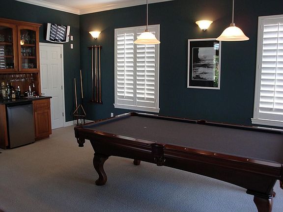 Entertainment room with wet bar, custom pool table and satellite TV