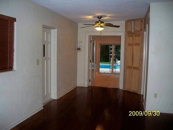 Family room looking thru the Florida room to pool.