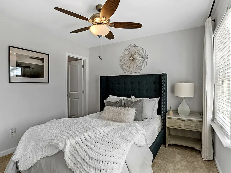 Spacious bedroom with overhead fan for year-round comfort
