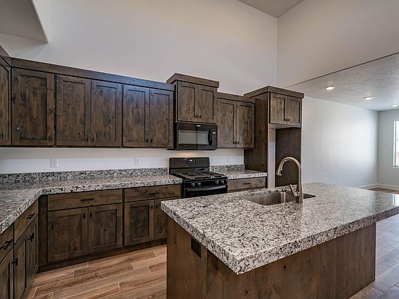 Kitchen with island, 15 foot ceiling with windows, flooded with light