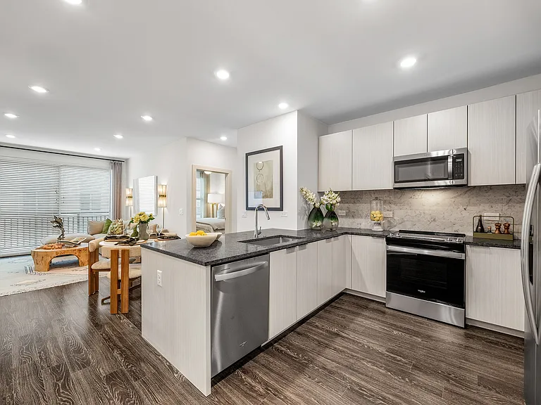 Modern open-plan apartment with stylish kitchen, inviting living area, and elegant decor, perfect for contemporary living.