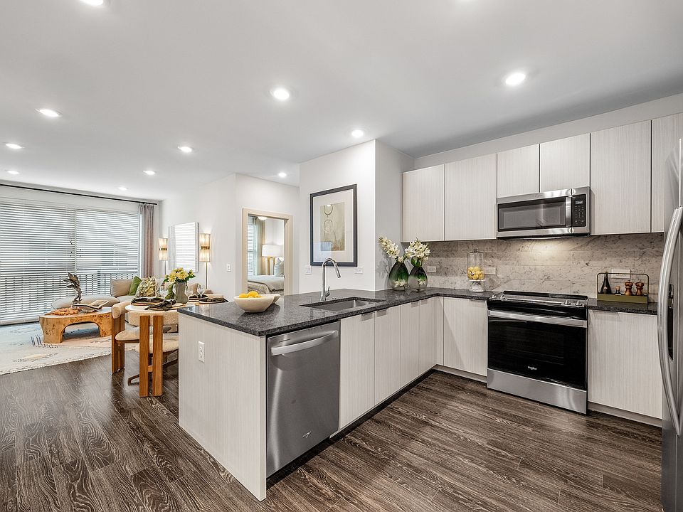 Modern open-plan apartment with stylish kitchen, inviting living area, and elegant decor, perfect for contemporary living.