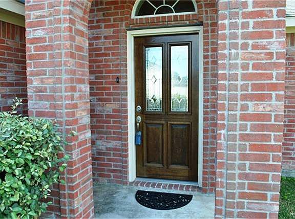 Your home has a gorgeous leaded glass front door and decorative window.