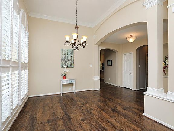 Elegant Formal Dining Room also has Double Crown Molding, Plantation Shutters & Updated Chandelier.