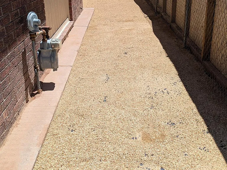 Side of house, on the right as you are facing the house.