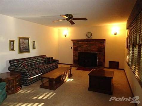 Formal living room with ceiling fan.