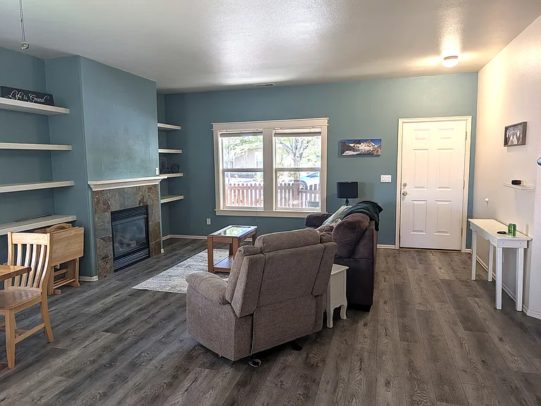 Living room with gas fireplace, couch and recliner