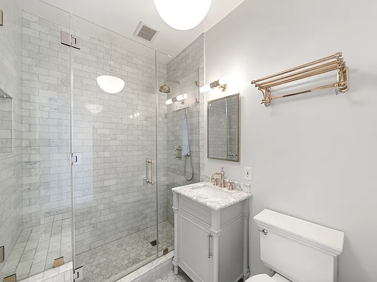 Upstairs bathroom with marble tiled shower