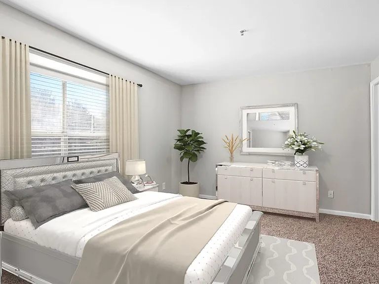 Bedroom with large window and plush carpeting at The Crossings at Russett in Laurel, MD