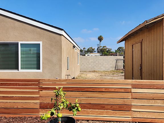Redwood fencing, side yard, and bicycle storage.