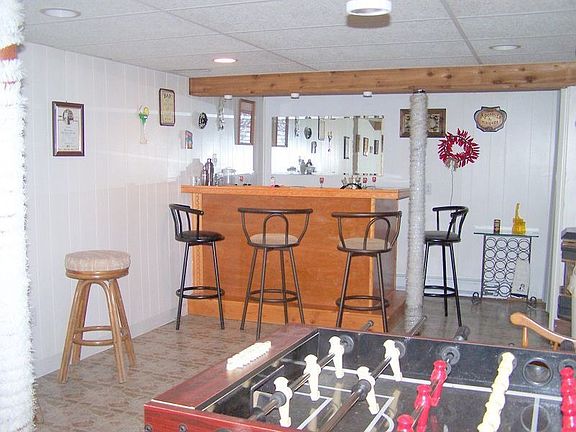 More room in the lower level with bar and pellet stove