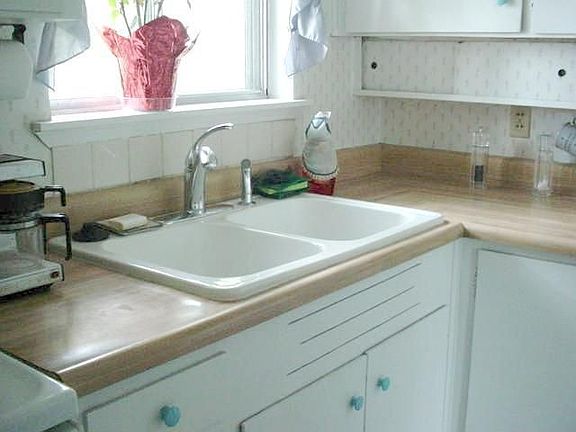 New sink, range hood, and garbage disposal.