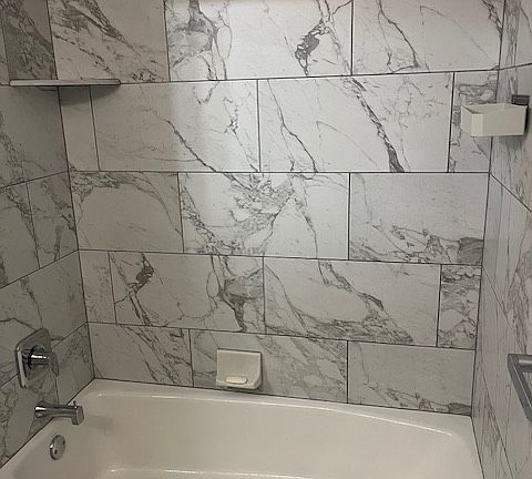 Main Full Bathroom: tub/shower and all tile surround.