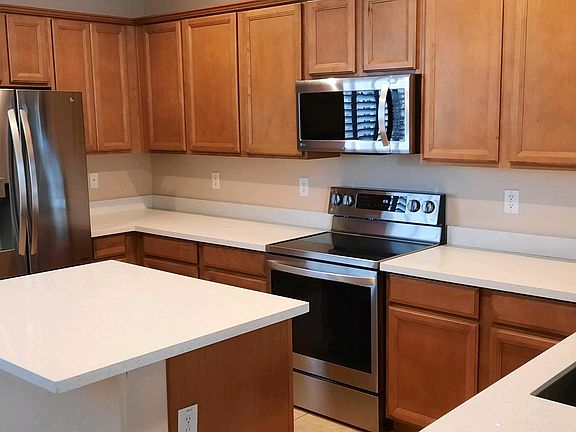 Ample counterspace, stainless appliances, and tall cabinetry are all fine features of this kitchen.