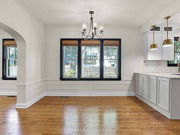 Open floor plan with arched entry from living to dining and kitchen.