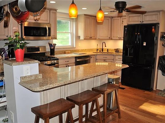Kitchen had quartz countertops, hardwood floor, and plenty of cabinet space. Room is 14x12.