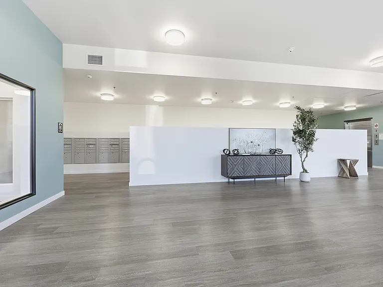 A stylish and inviting lobby entrance with comfortable seating, convenient tables, and easy access to restrooms_designed to offer a welcoming space for residents and guests alike.
