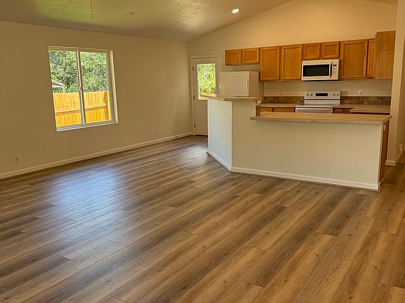 Bright and airy living room with fresh paint, new luxury vinyl plank flooring, and an open layout ready for relaxing or entertaining.