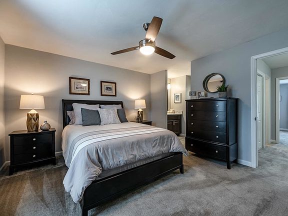 Bedroom with queen bed, dresser and night stands