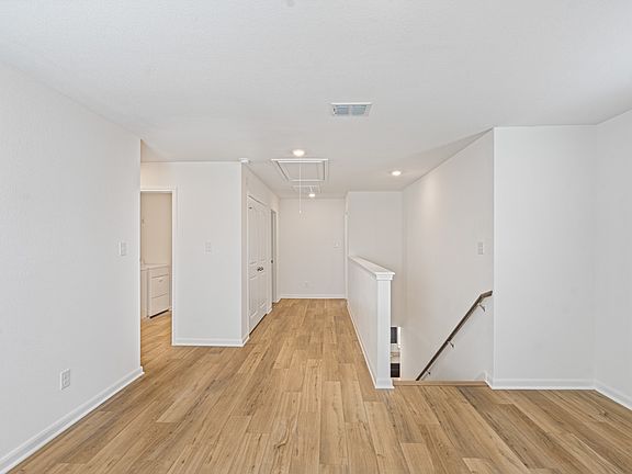 Upstairs loft space, providing an area for a game room or home office.