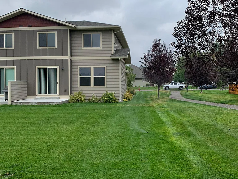 REAR OF CONDO WITH PATIO