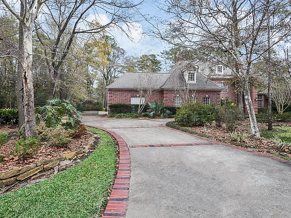 The circular driveway winds around the house to the rear-facing 3-car garage. A driveway gate keeps pets and little ones safe.