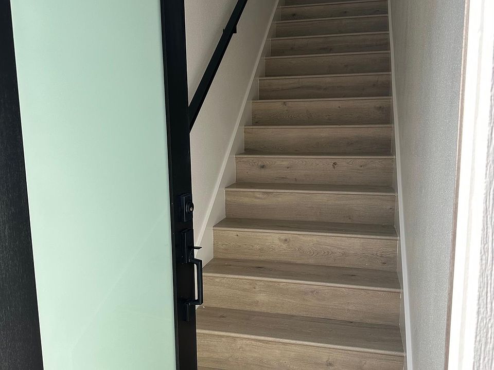 Covered stairway leading to above garage ADU.