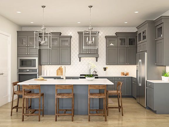 Kitchen with pendant lights and glass upper cabinets