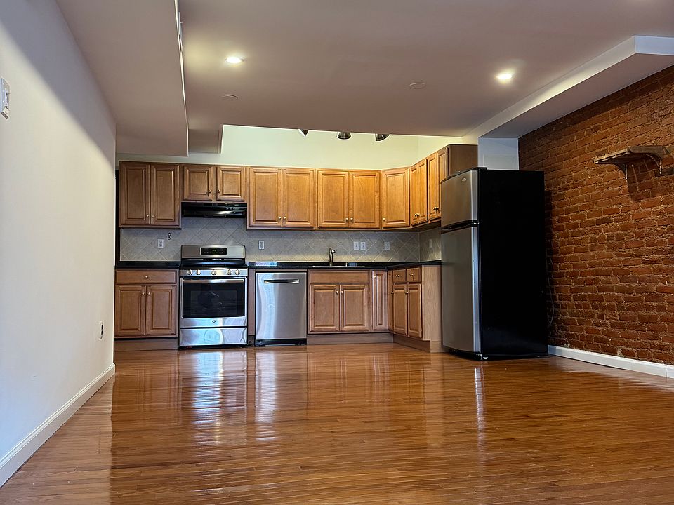 Kitchen and living room with exposed brick