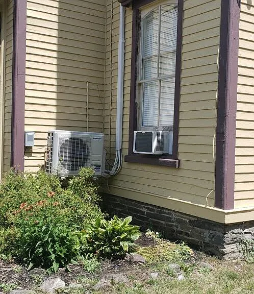 Mini-split compressor on outside of house.
