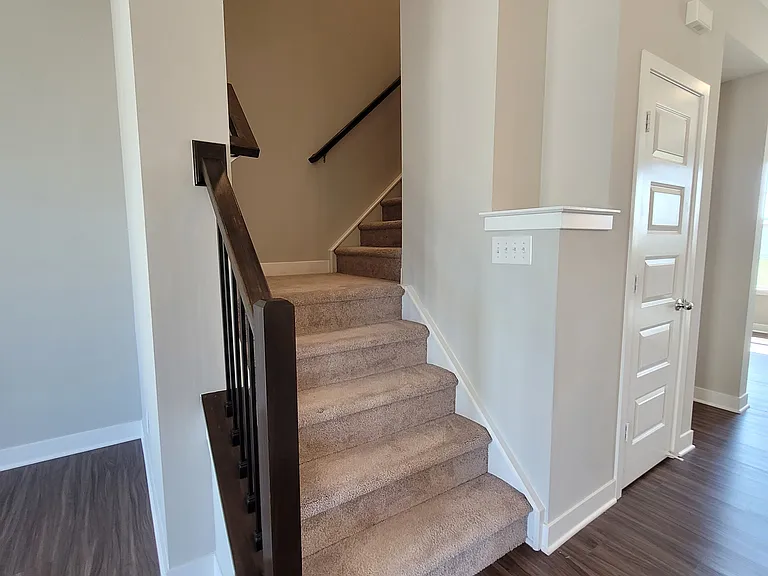 Stairs to the third floor and the 3 bedrooms