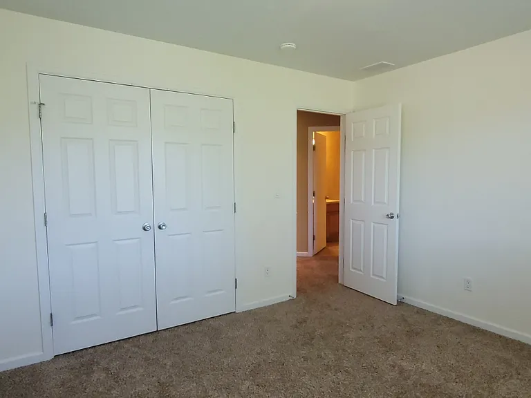 First bedroom at the top of the stairs Looking into the hall towards the guest bathroom.