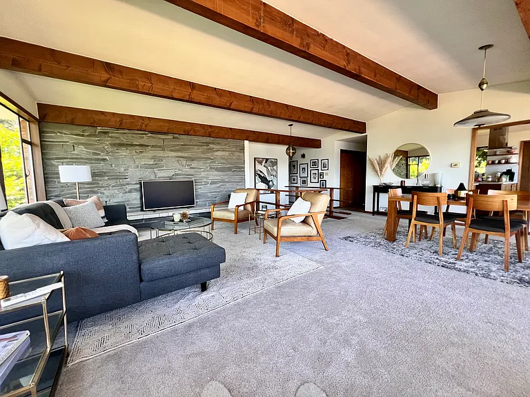 Open concept living and dining with original mid-century lighting fixtures.
