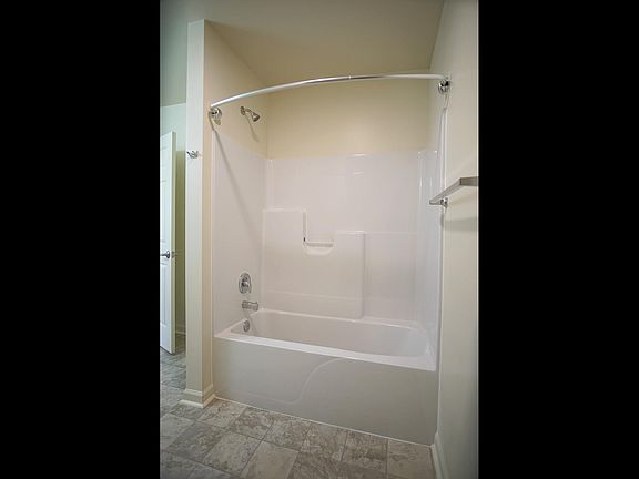 One of two downstairs full baths each with tub shower unit.