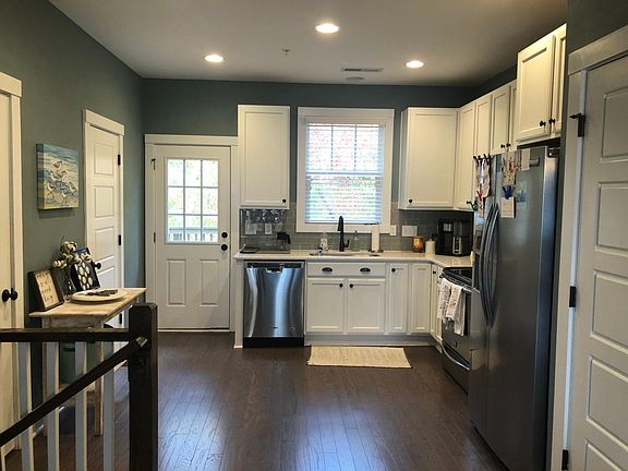 Kitchen - doors to pantry, coat closet, half bath, and deck. Stairs to bottom floor. (Main floor).