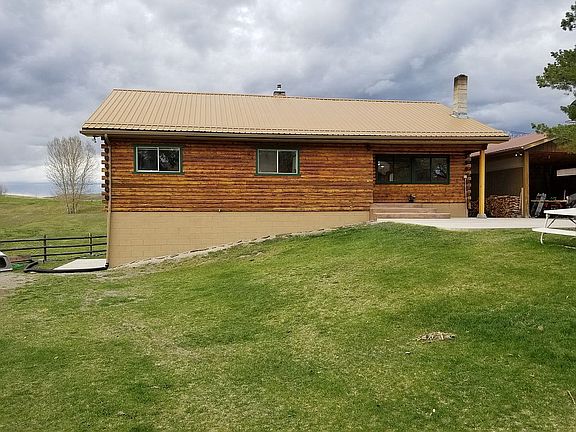 House front, patio and lawn.