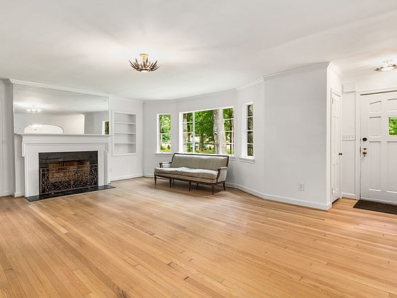 Spacious living room with lots of natural lighting and a wood burning fireplace