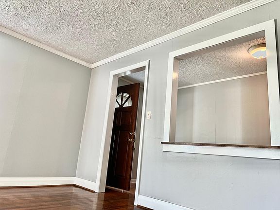 Living room area, view to front hallway and front door