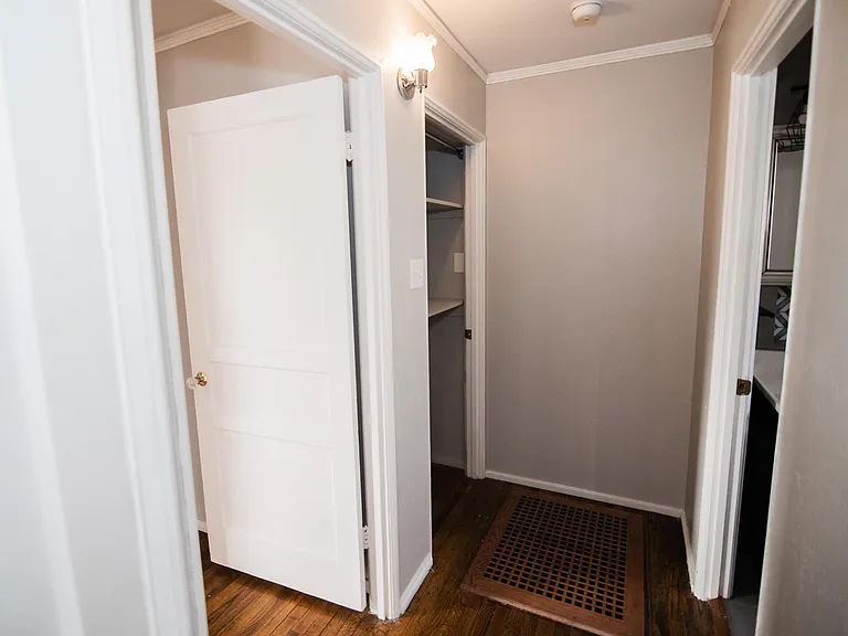 Hallway between bedrooms to bathroom with additional closet