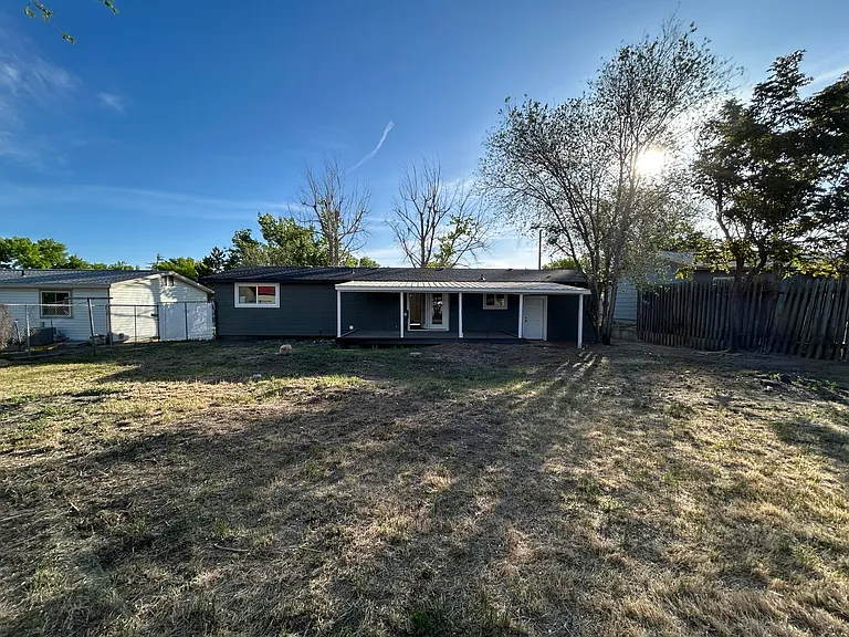Back of house view. Backyard is mostly fenced.