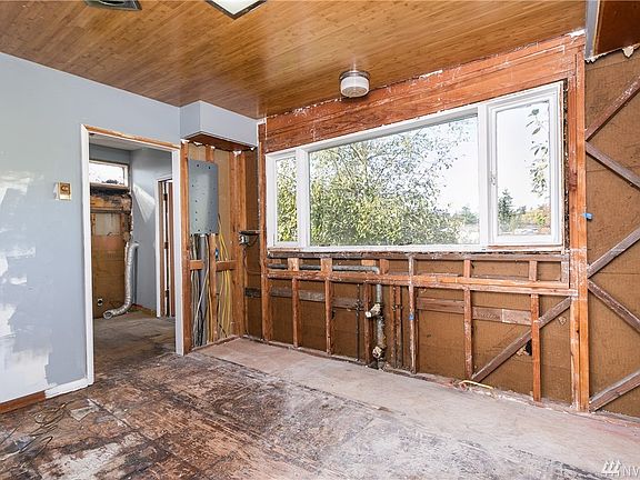 Kitchen area ready for your imagination to run wild.  Water, electricity all in.  Large window allows lots of light and looks out back to deck and backyard.  Door leads to laundry/pantry.  Open up and make dining with closet laundry?  Possibilities everywhere.