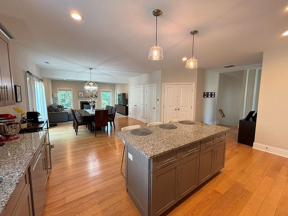 Main floor, kitchen with stainless steel appliances and granite countertops. Opens into dining room and family room, open concept floor plan. Hardwood floors and carpeting. Access to small deck. Washer and dryer hookups.