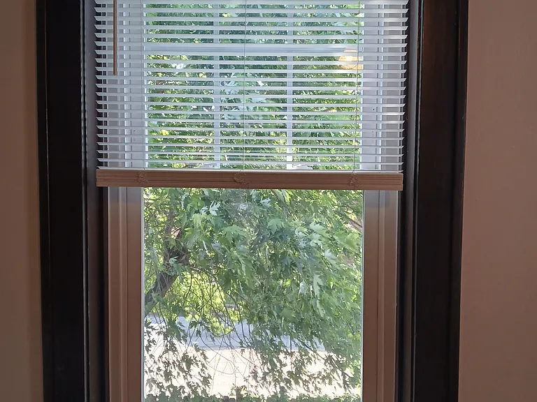 Bedroom overlooks fenced backyard